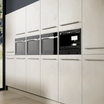 Flat doors, with large feature handles, bank of ovens. 