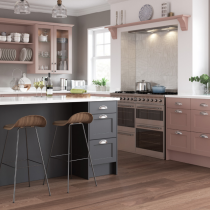 Shaker style kitchen, glass doors, plate rack, island with seating. 
